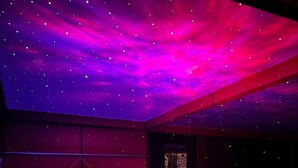 A room with a starry ceiling, a bathtub, and a table with a patterned tablecloth. - Desire Stay (New Delhi)
