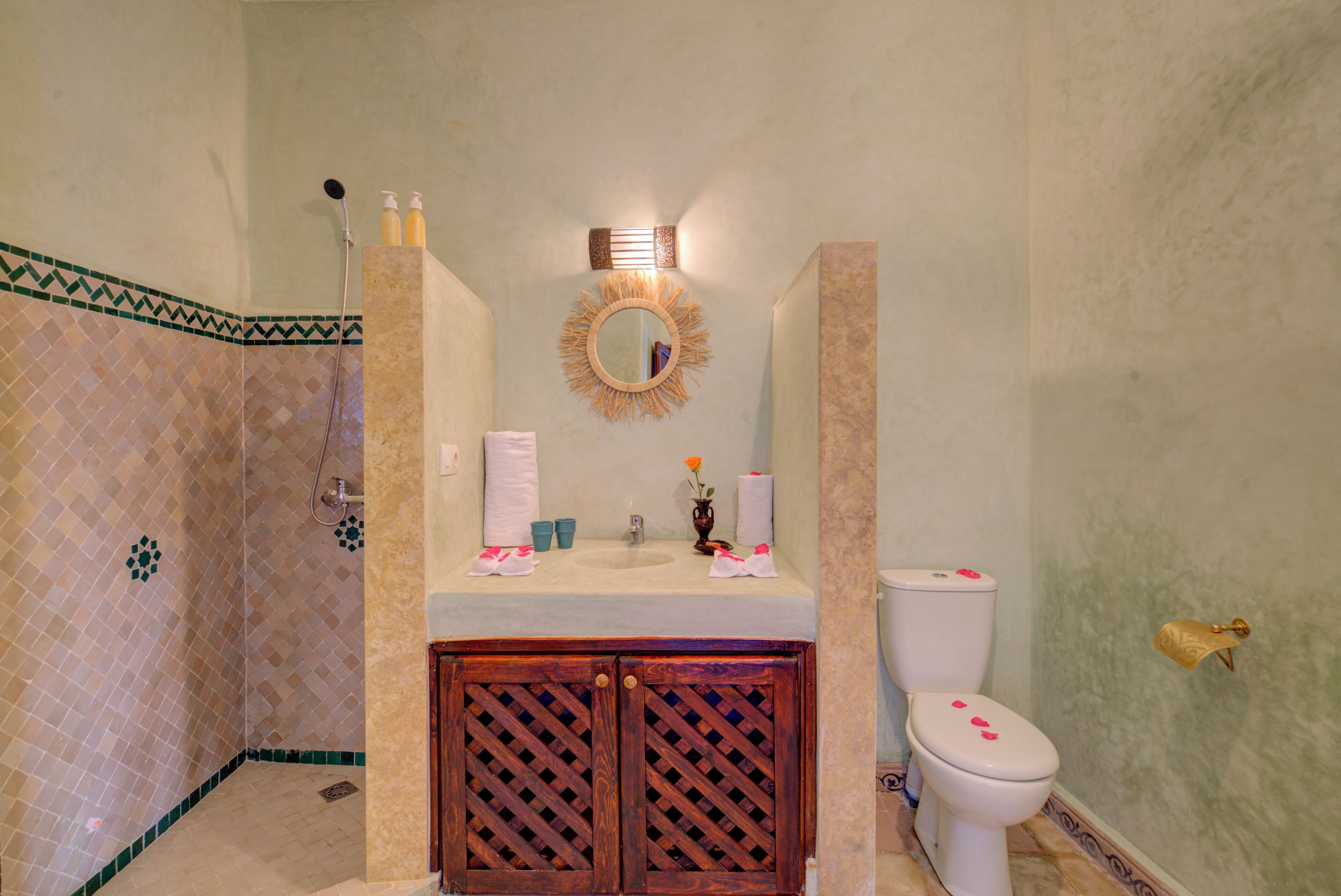 A bathroom with a shower, sink, toilet, and vanity.