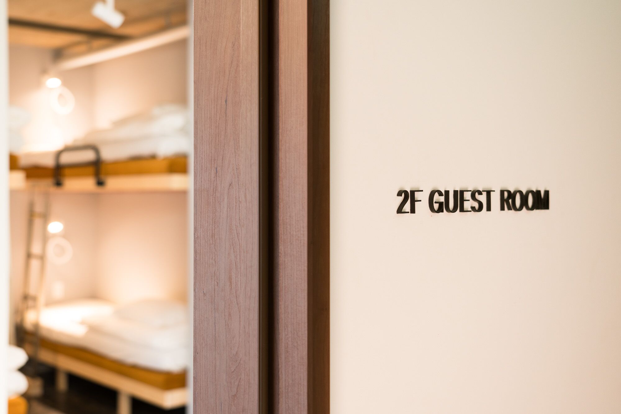 A bunk bed with a sign indicating "2F GUEST ROOM".
