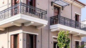 A multi-story building with balconies, a small tree, and a clear sky. - The Owl House - Studio #2 (Chania)