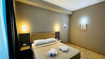 Deluxe Triple Room | Minibar, in-room safe, desk, blackout curtains