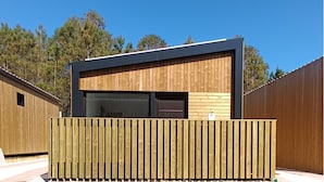 A modern building with a wooden facade and a black upper section. - Top Balea (O Grove)