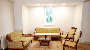 A living room with a sofa, armchairs, and a coffee table.
