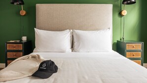 A neatly made bed with white linens, two black lamps with wooden bases, and a green wall. - Sosuite 2BR Loft w W/d, Shared Roofdeck (Philadelphia)