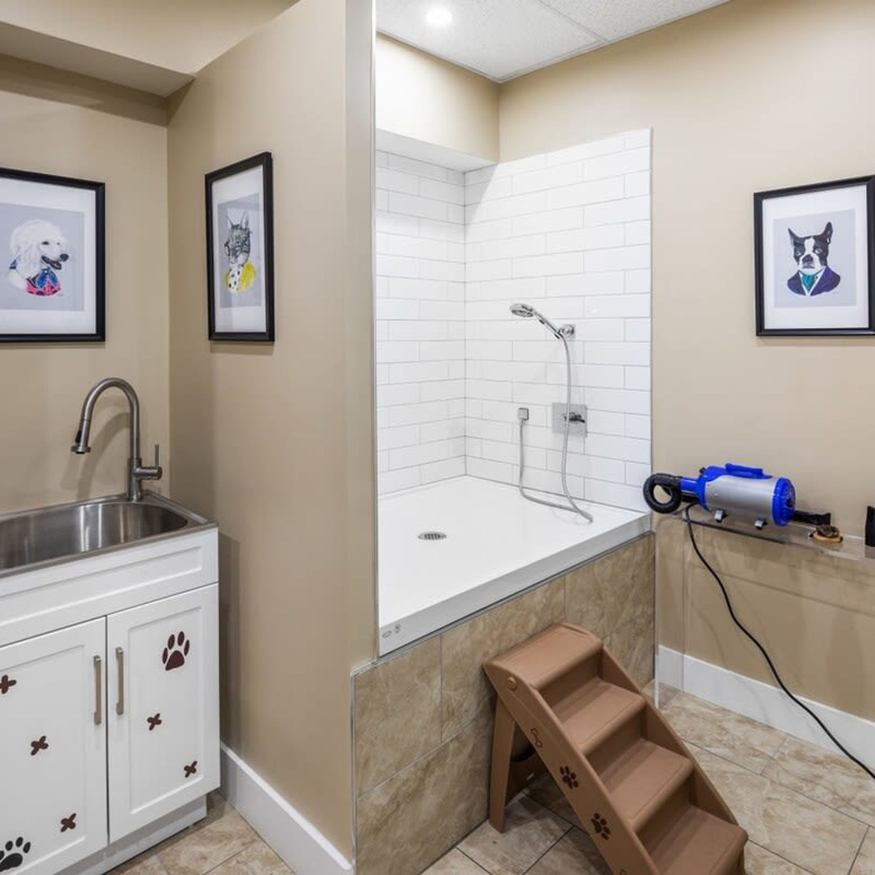 A bathroom with a shower, a sink, and a dog-themed cabinet.