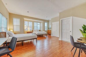 A spacious bedroom with two beds, a desk, and a chair. - Cherry Suites 3BR Apt w W D Foosball Table (Philadelphia)