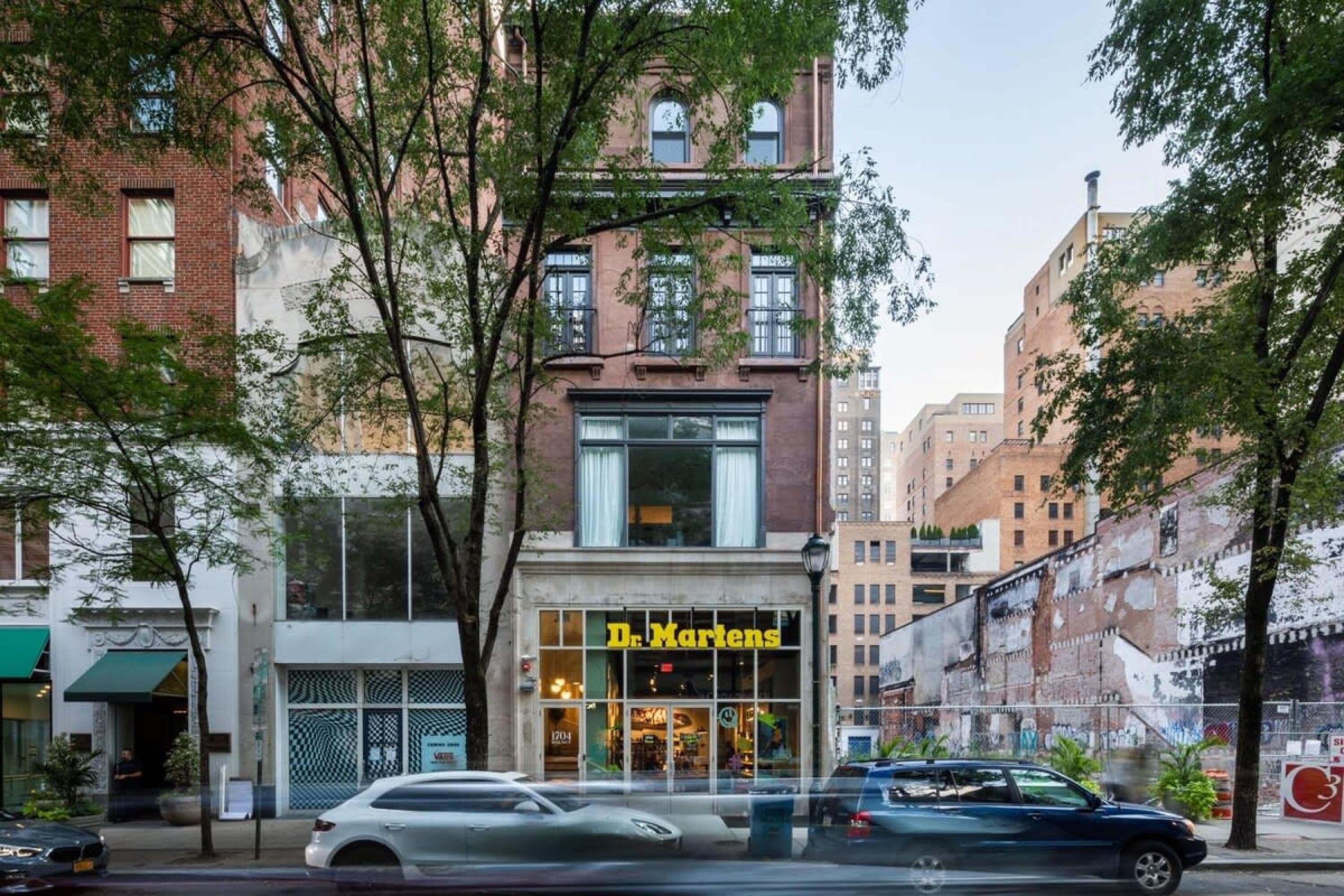 A street view with a building labeled 'Dr. Martens' featuring large windows and a storefront.