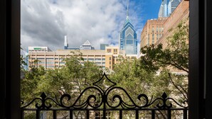 A cityscape with modern buildings, including a distinctive skyscraper with a pointed top. - Sosuite Juliet Balcony 1BR Apt w W D Desk (Philadelphia)