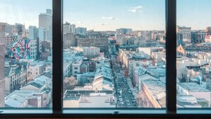 A cityscape through a window with a grid pattern. - Sosuite 2BR Penthouse w Balcony W D Gym (Philadelphia)