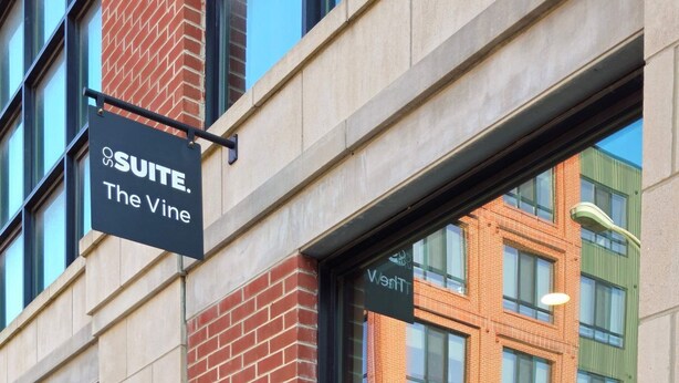 A hotel entrance with a sign reading "222 SUITE. The Vine." - Sosuite Corner 1BR Apt w W/d, Shared Roofdeck (Philadelphia)