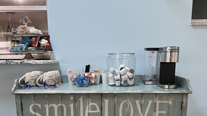 A wooden cabinet with the words "SMILE LOVE DANCE party SING celebrate LAUGH play" painted on it.