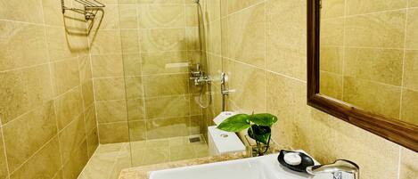 A bathroom with a bathtub, a shower, and a sink.