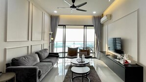 A modern living room with a sofa, coffee table, and TV. - Country Garden Danga Bay (Johor Bahru)