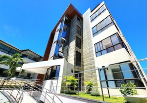 A modern multi-story building with large windows and a glass facade.