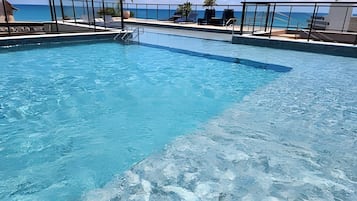 Outdoor pool, open 9:00 AM to 9:00 PM, pool umbrellas, pool loungers
