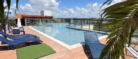 Outdoor pool, open 9:00 AM to 10:00 PM, pool umbrellas, pool loungers