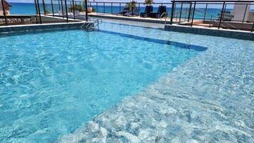 Outdoor pool, open 9:00 AM to 10:00 PM, pool umbrellas, sun loungers