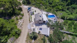 An aerial view of a property with a swimming pool, a dirt path, and surrounding greenery. - Villa Blue Bay with private pool (Selca)