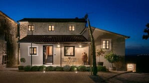 Traditional country house with a front entrance, porch, and garden.