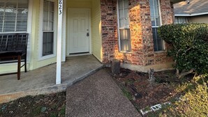 A two-story house with a brick facade, a front porch, and a mailbox. - Sleeps8.No Stairs,Carpet-Free Near Dallas Stadiums (Arlington)