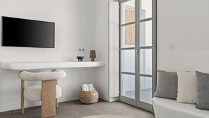 A modern bathroom with a large mirror, a toilet, and a sink. -  Mr and Mrs White Paros Suites and more (Paros)