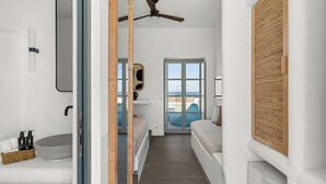A modern bathroom with a large mirror, a round sink, and a ceiling fan. -  Mr and Mrs White Paros Suites and more (Paros)