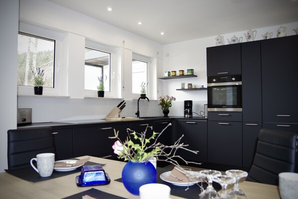 Fridge, stovetop, dishwasher, coffee/tea maker