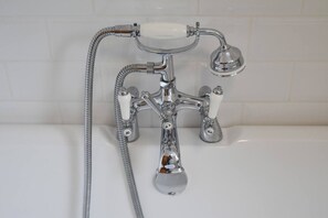 A chrome bathroom fixture with a handheld showerhead, a separate faucet, and a soap dish. - Haven Breeze | 5mins to Sea Front | Family Home (Portsmouth)