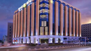 A modern hotel with a prominent 'NOVO Hotel' sign, large windows, and a well-lit facade. - Novo Hotel Riyadh (Riyadh)