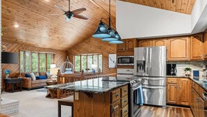 A spacious kitchen with wooden cabinets, stainless steel appliances, and a large island.