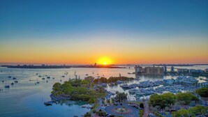 A marina with numerous boats docked, a bridge in the background, and a sunset over the water. - Charming 3-bedroom house with private pool  and in delightful Sarasota...  (Sarasota)