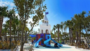 A playground with a castle-like structure, slides, and a sandy area. - Charming 3-bedroom house with private pool  and in delightful Sarasota...  (Sarasota)