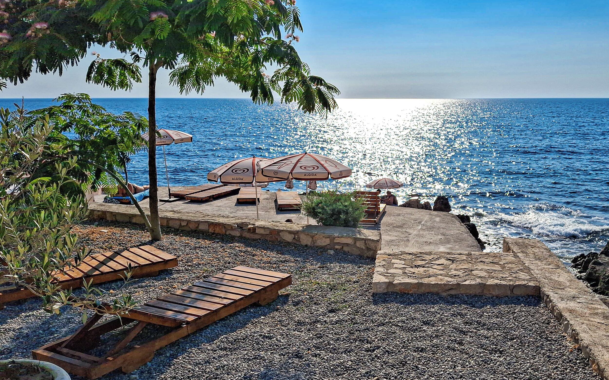 Private beach, black sand, sun loungers, beach umbrellas