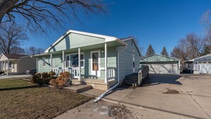 A single-story house with a front porch, a garage, and a driveway. - A Home away from Home (Waterloo)