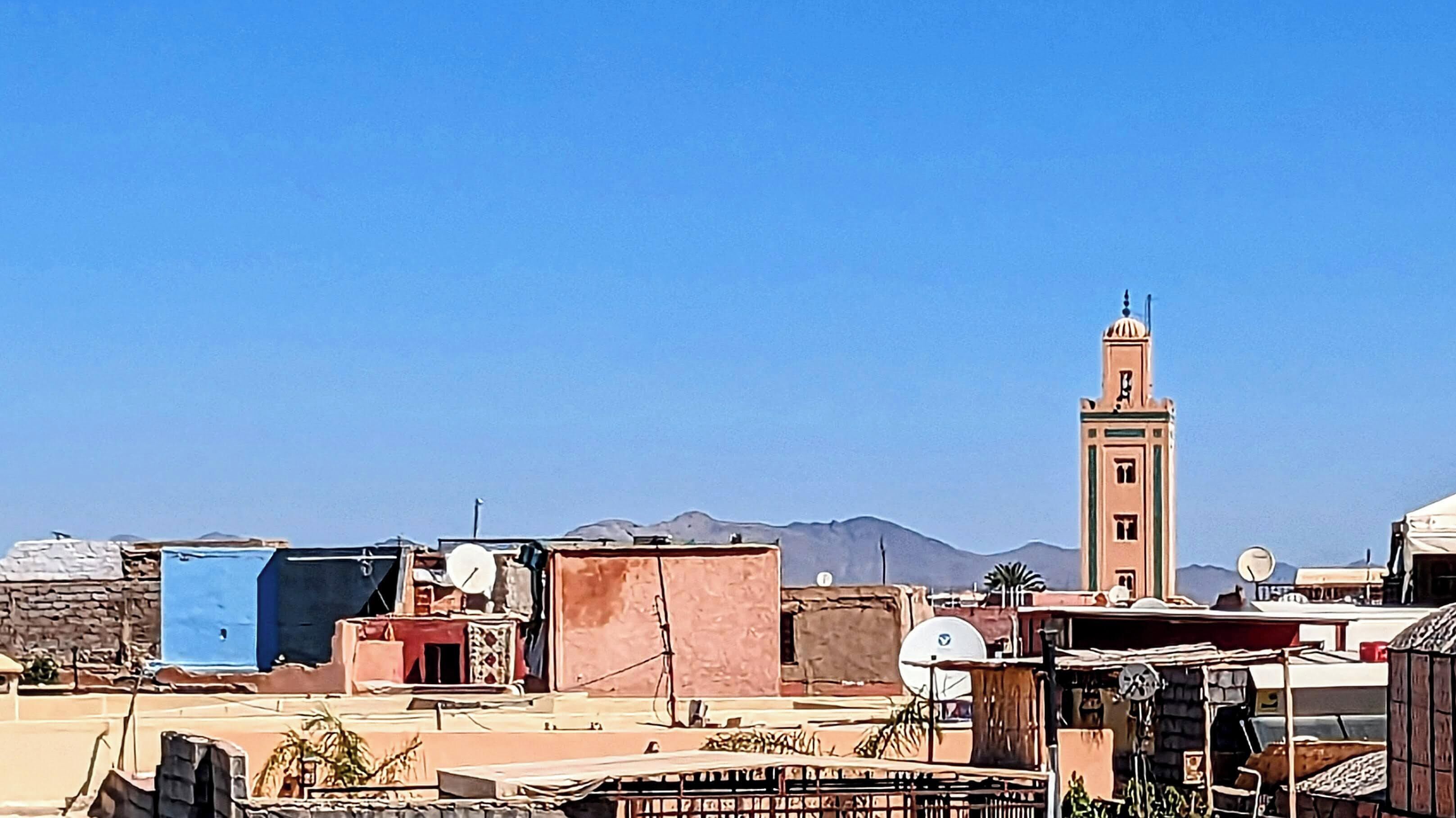 A rooftop with various structures, including a tower with a dome and a satellite dish.