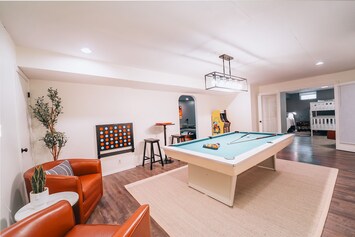 Fun-filled game room with pool, Pac-Man arcade, foosball, basketball, and more!
