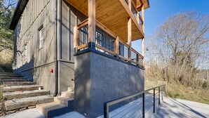 A two-story building with a wooden balcony and a stone staircase leading to the entrance. - Historic Hollister Home: Shop, Dine & Drink Nearby (Hollister)