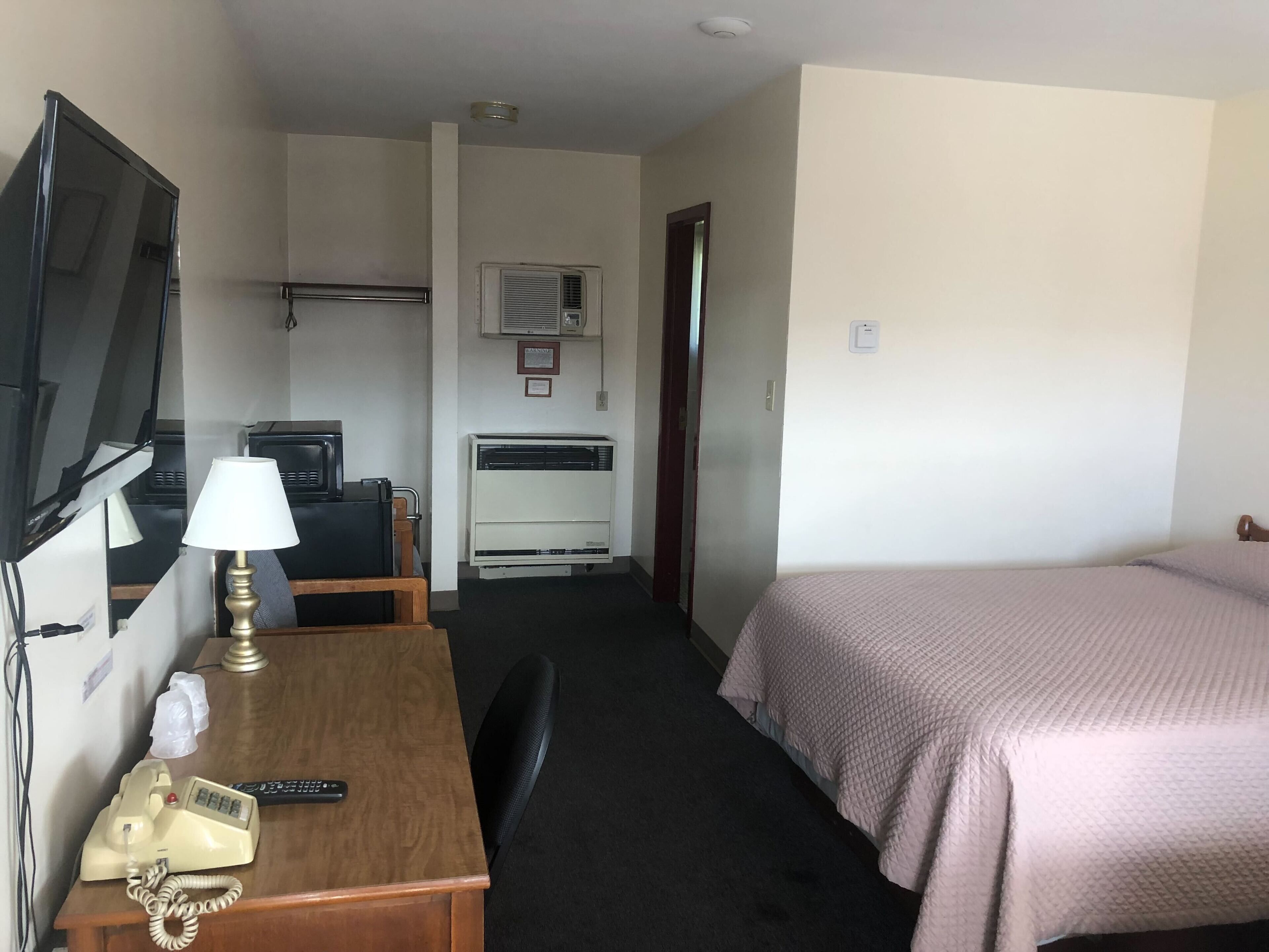 Desk, laptop workspace, blackout drapes, iron/ironing board