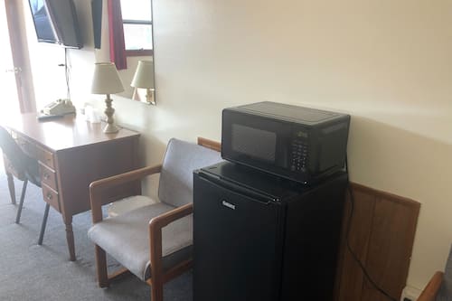 Desk, laptop workspace, blackout drapes, iron/ironing board