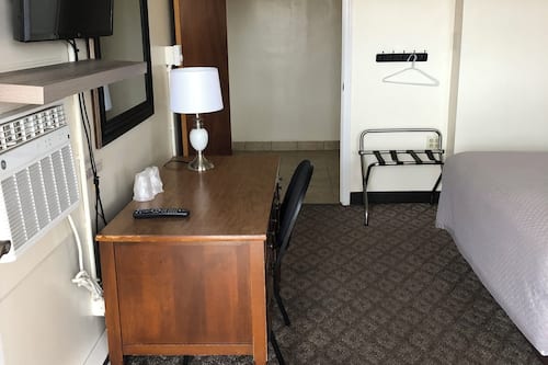 Desk, laptop workspace, blackout drapes, iron/ironing board