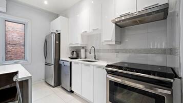 Fridge, coffee/tea maker, highchair, cookware/dishes/utensils