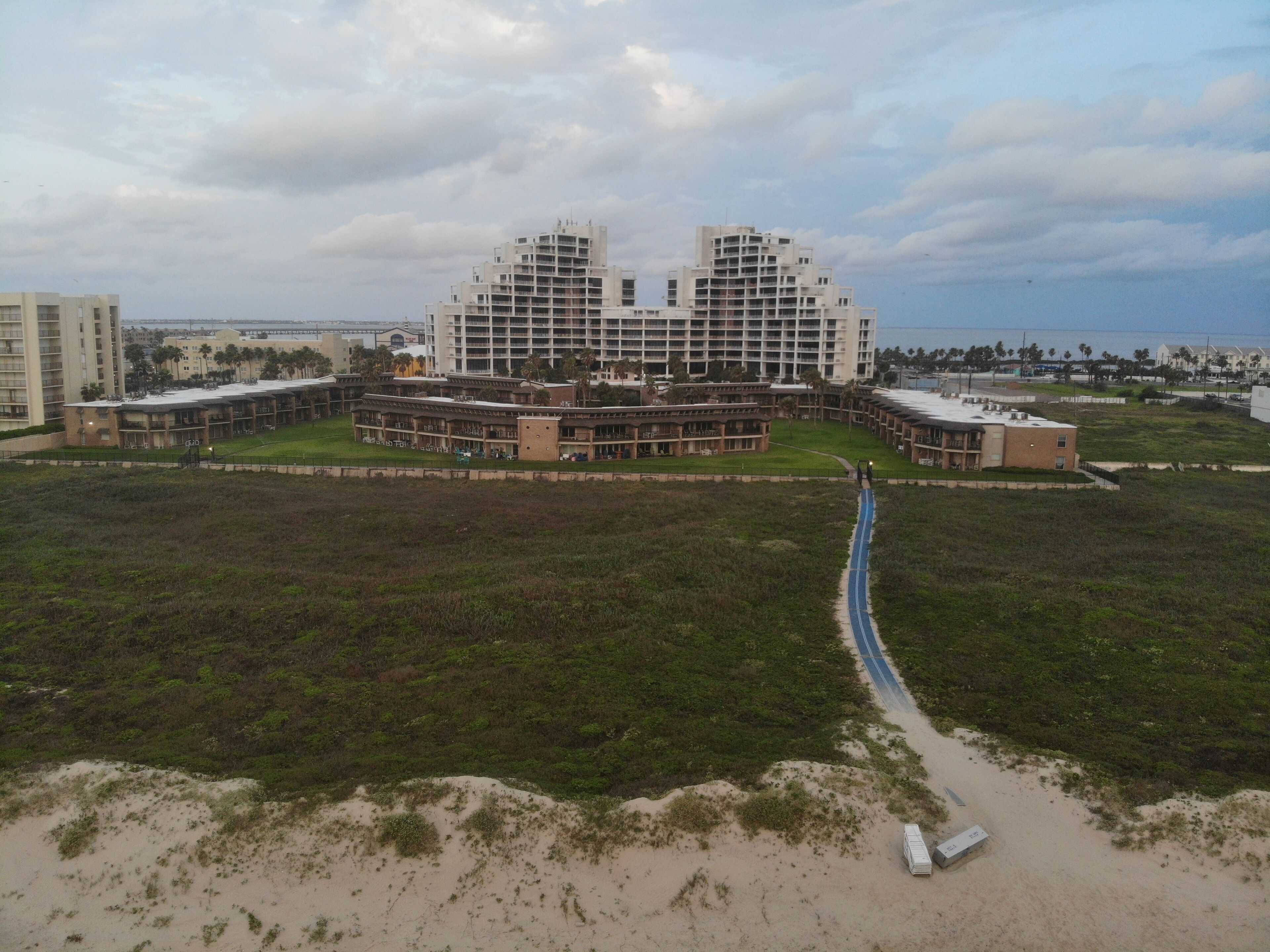 A large hotel with multiple floors and a central courtyard.