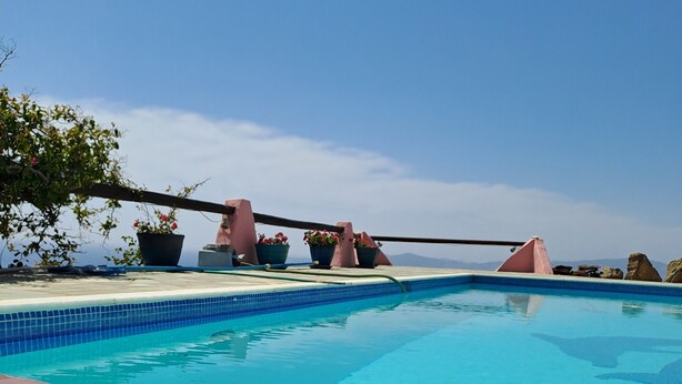 A clear blue pool with a glass of fruit and a drink on the edge. - Dorothea Panoramic Villa.One of a kind, a hidden gem on the isle of Paros.Helios (Paros)