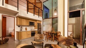 A spacious loft with a kitchen, dining area, and seating. - Azalea 5 Condos 8BR 23 PPL  Private Pool (Tulum)