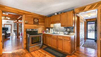 Coffee/tea maker, highchair, cookware/dishes/utensils, dining tables