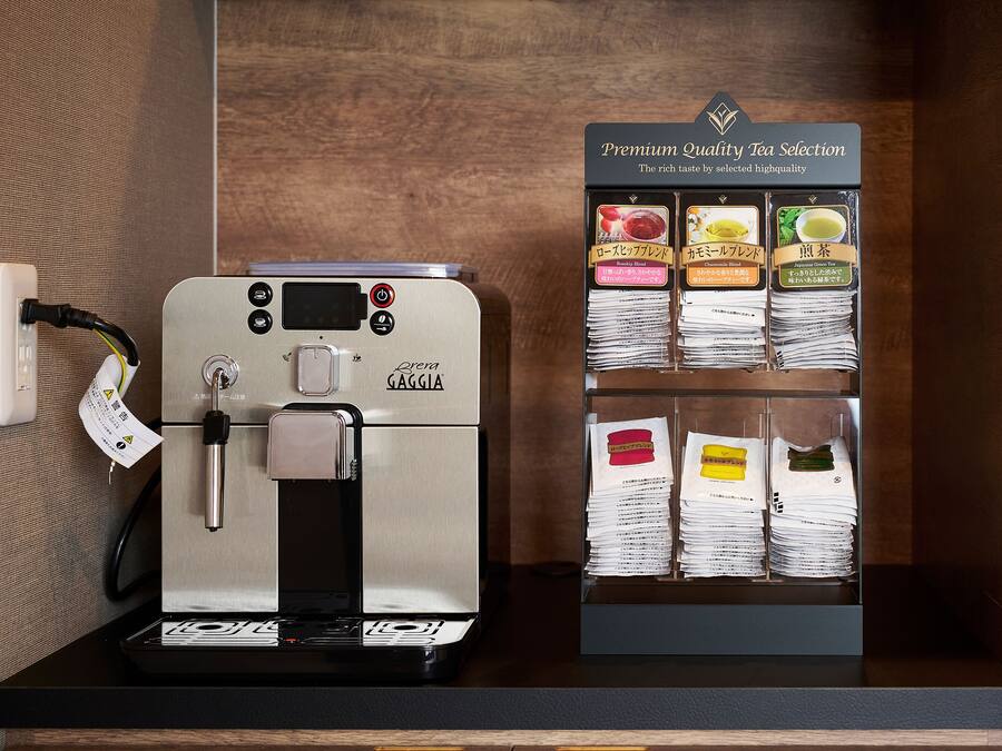 A coffee machine with a selection of tea bags.