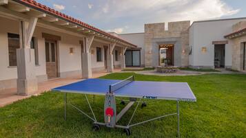 Enjoy a game of ping pong in the serene courtyard, surrounded by lush greenery and a beautifully maintained lawn.
