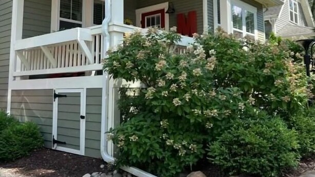 A two-story house with a porch, a mailbox, and a number '109' on the side. - Modern Cottage "M" Luxury home w/hot tub, community pool-walk to town & beach (New Buffalo)