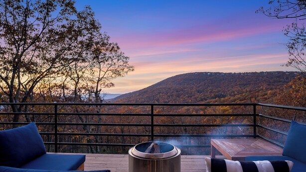 A balcony with a view of a forested hillside during sunset. - Amazing Views / Hot Tub / 15 mins to Wineries / 3200 sq ft (Wintergreen Resort)