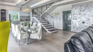 A modern interior with a dining area, staircase, and living space. - Villa Over the Hilltop by Interhome (Motovun)